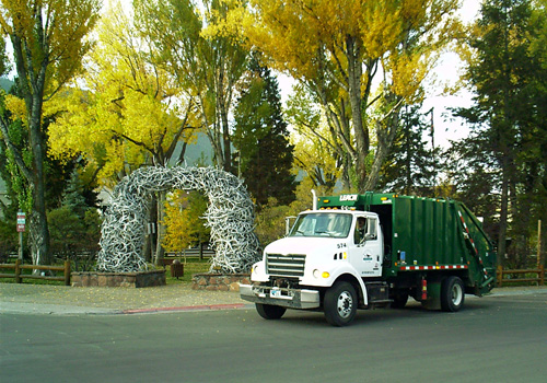 Westbank Sanitation rear load commercial garbage truck.